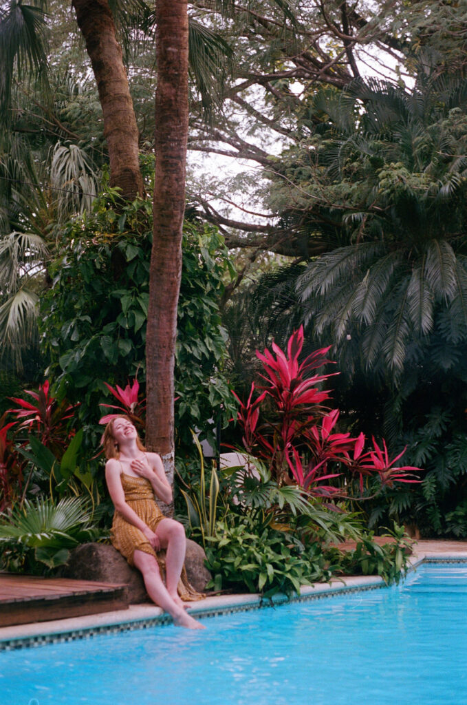 Woman laughing by pool in jungle of Costa Rica
