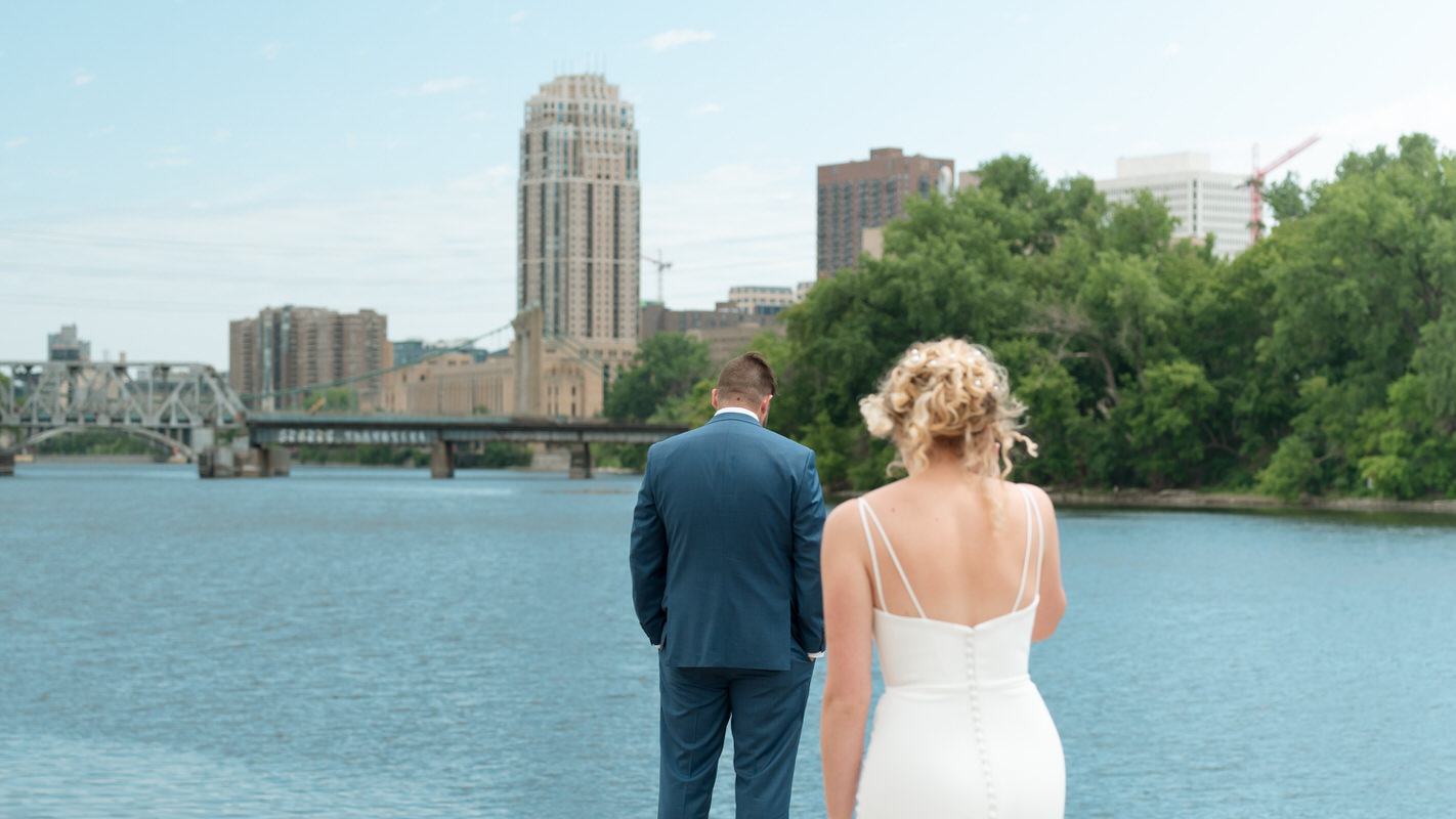 bride and groom first look in front of the minneapolis skyline