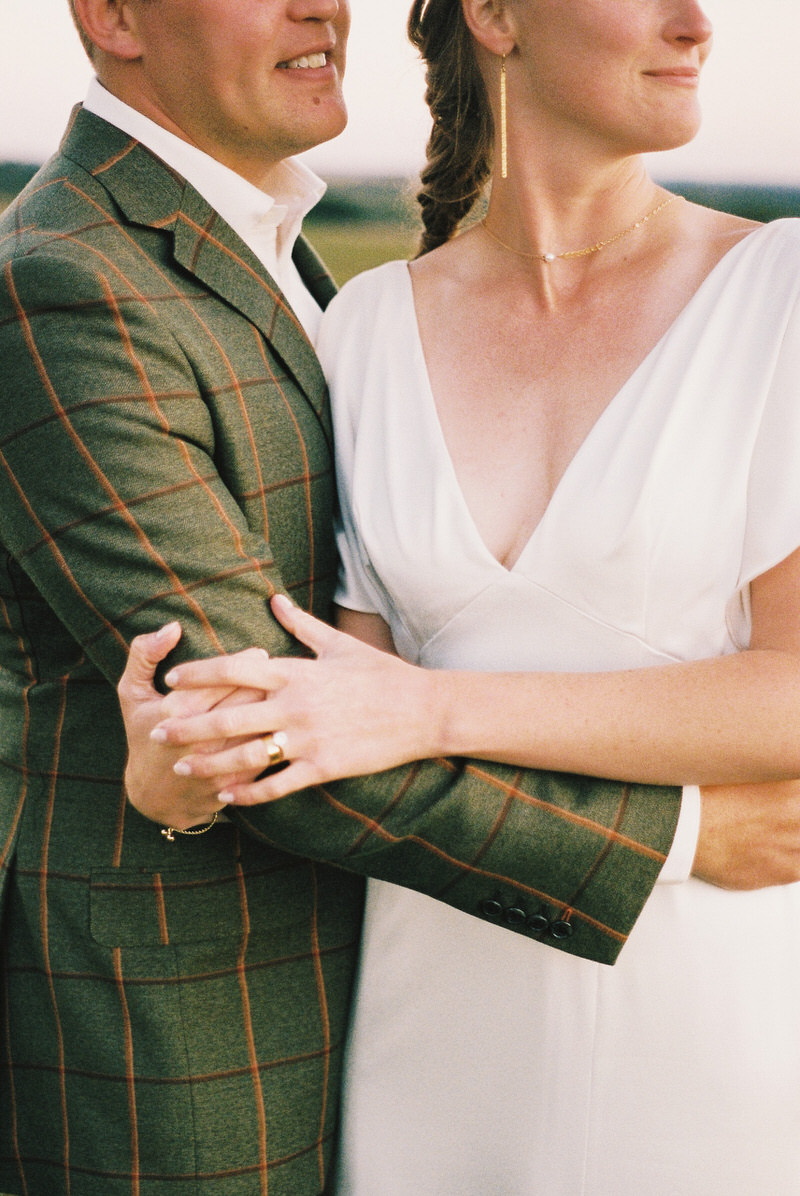 Bride and groom sharing a quiet moment at their outdoor tent wedding in Wisconsin, surrounded by rolling hills and golden light